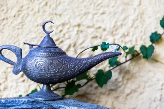 The brass oil lamp — the lyhnari — on the whitewashed garden wall