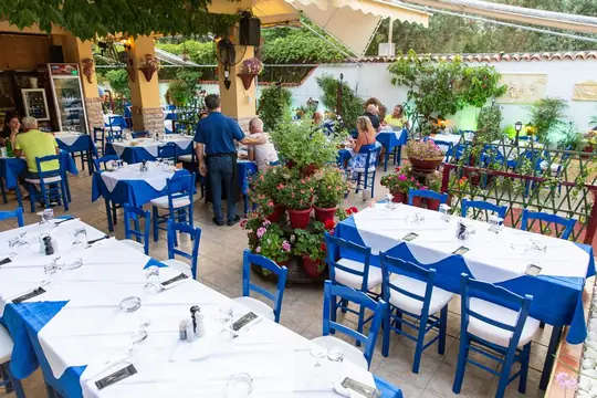 Blue chairs and set tables down the length of the courtyard
