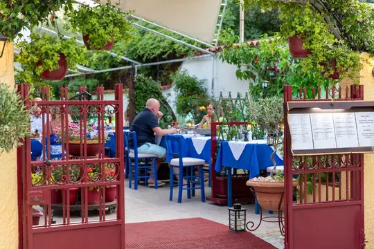 The red garden gate and the menu board at the entrance