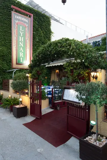 The entrance at dusk, red carpet leading in